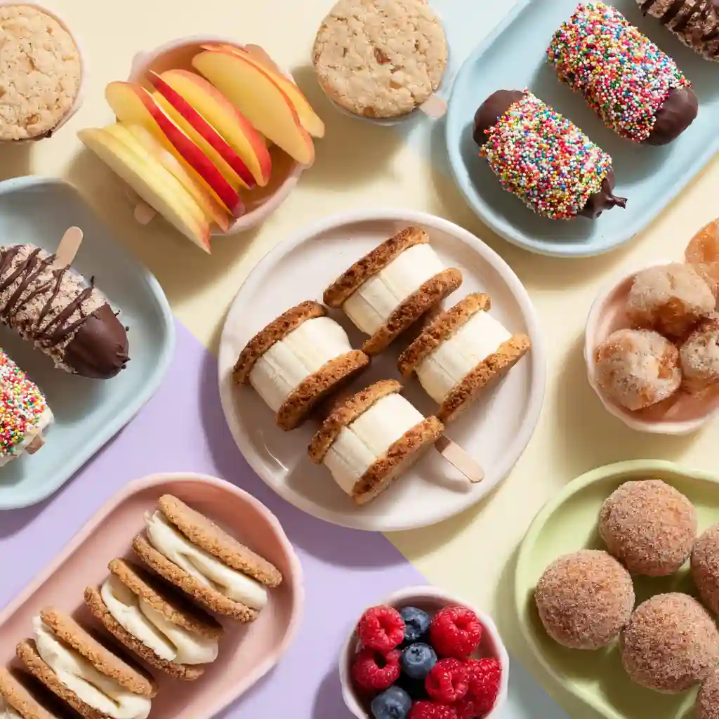 Collage of kid-friendly vegan gluten-free desserts including chocolate banana pops, simple oat cookies, apple slice sandwiches, mini berry cups, and soft cinnamon donut holes